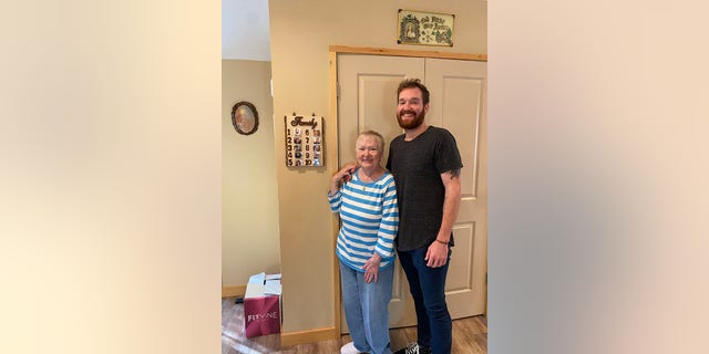 Dan and Nanny LaMorte snap a photo in front of the current ranking of the LaMorte grandchildren.