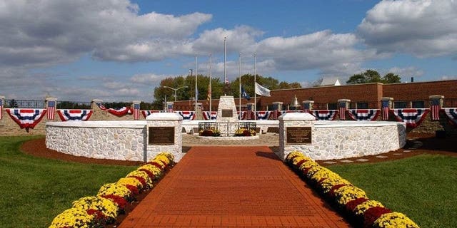 FILE - Flags at the Fallen Firefighters Memorial in Maryland are lowered to half-staff in honor of Dalhart firefighters killed in the line of duty.