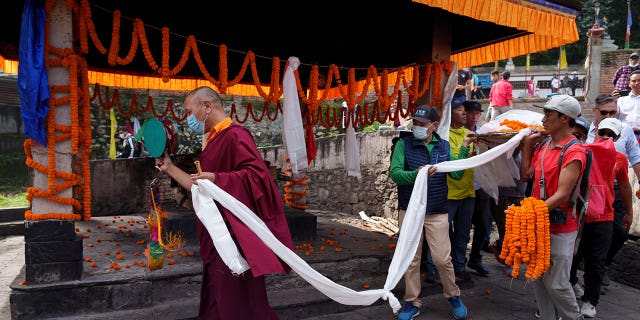 Buddhist monks perform a ceremony at the funeral of famed extreme skier Hilaree Nelson in Kathmandu, Nepal, on Oct. 2, 2022.