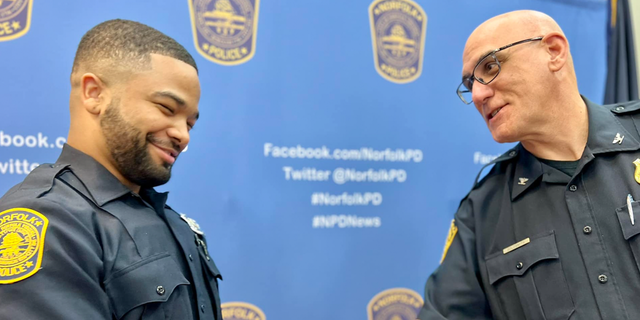 Norfolk Police Chief Michael Goldsmith welcoming an officer after swearing him.