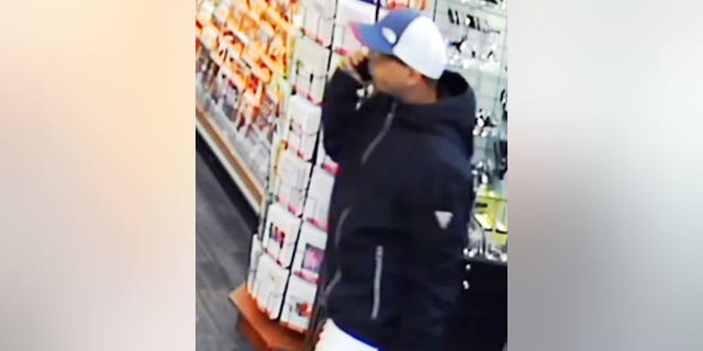 One of the suspects in the Oct. 13 robbery seen on the phone. 