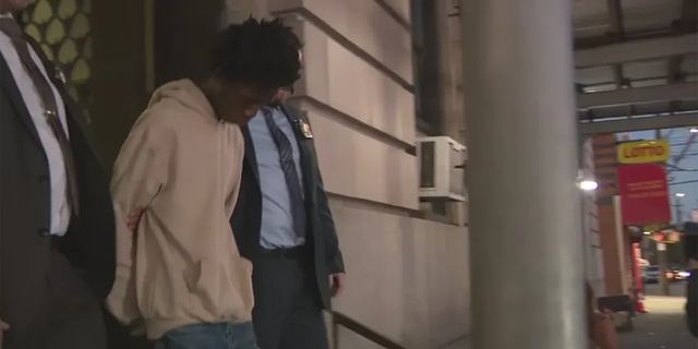 Keyondre Russell escorted from the NYPD 101st Precinct after his arrest for the murder of Jayjon Burnett.
