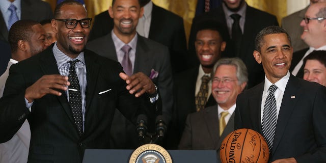 Miami Heat player LeBron James, left, speaks to President Barack Obama during an event to honor the NBA champion Miami Heat in the East Room at the White House in Washington, D.C., on Jan. 28, 2013.