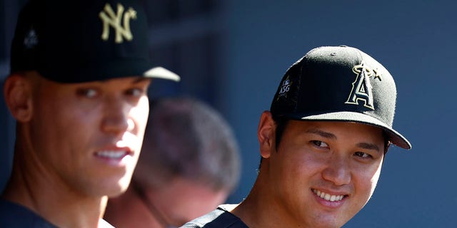Aaron Judge of the New York Yankees, left, and Shohei Ohtani of the Los Angeles Angels look on from the dugout before the All-Star Game at Dodger Stadium on July 19, 2022, in Los Angeles.