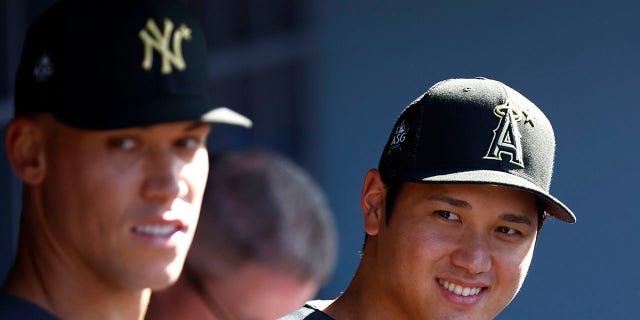 Aaron Judge of the New York Yankees, left, and Shohei Ohtani of the Los Angeles Angels look on from the dugout before the All-Star Game at Dodger Stadium on July 19, 2022, in Los Angeles.