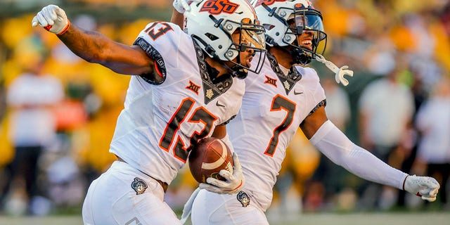 Oklahoma State defenders Thomas Harper (13) and Jabbar Muhammad (7) celebrate an interception during the second half of a game against Baylor in Waco, Texas, Saturday, Oct. 1, 2022.