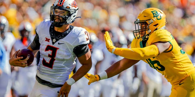 Oklahoma State quarterback Spencer Sanders (3) passes Baylor linebacker Tyrone Brown (36) in the first half of a game on Saturday, Oct. 1, 2022 in Waco, Texas.