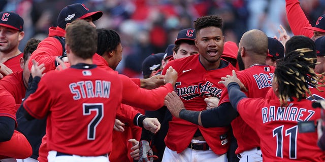 Oscar Gonzalez of the Cleveland Guardians celebrates with teammates after hitting a walk-off home run in the 15th inning against the Tampa Bay Rays in the second game of the wild-card series at Progressive Field on Oct. 8, 2022, in Cleveland.