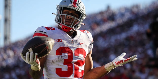 TreVeyon Henderson #32 of the Ohio State Buckeyes reacts after scoring a touchdown against the Penn State Nittany Lions during the second half at Beaver Stadium on October 29, 2022 in State College, Pennsylvania.