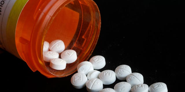 Oxycodone pills seen from a prescription bottle on Aug. 29, 2018.