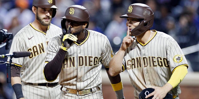 Austin Nola #26, Jurickson Profar #10, and Ha-Seong Kim #7 of the San Diego Padres celebrate a three-run home run hit by Profar during the fifth inning of Game One of the NL Wild Card Series against the New York Mets at Citi Field on October 07, 2022 in the Flushing neighborhood of the Queens borough of New York City.