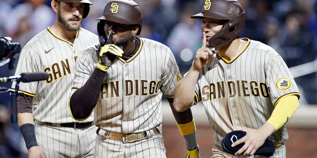 San Diego Padres' Austin Nora #26, Jurrickson Plofer #10 and Ha-sung Kim #7 hit a three-run home run by Ploffer in the fifth inning of Game 1 of the NL Wild Card Series against the New York Mets. celebrate the  October 7, 2022 at Citi Field in the Flushing neighborhood of Queens, New York City.