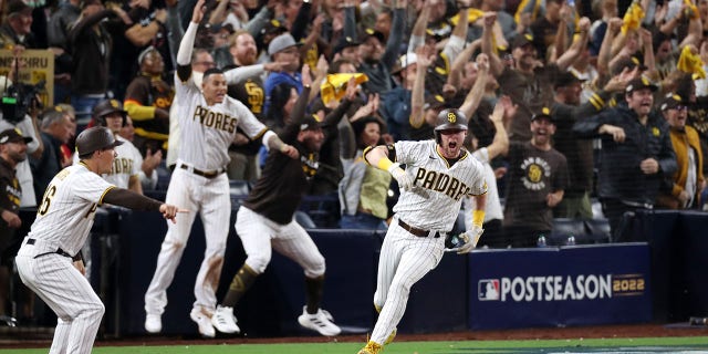 Jake Cronenworth #9 of the San Diego Padres celebrates after hitting a two-run RBI single during the seventh inning against the Los Angeles Dodgers in game four of the National League Division Series at PETCO Park on October 15, 2022 in San Diego, California.