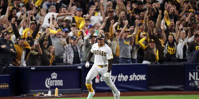 Juan Soto #22 of the San Diego Padres celebrates after hitting a RBI single during the seventh inning against the Los Angeles Dodgers in game four of the National League Division Series at PETCO Park on October 15, 2022 in San Diego, California.