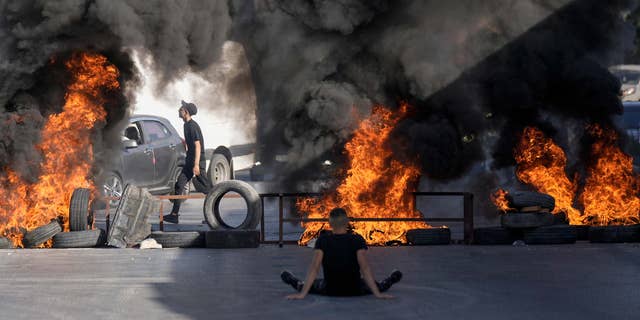 Tires were set on fire at the site where two Palestinians were shot and killed by Israeli forces in the Jalazone refugee camp near the city of Ramallah, West Bank, on Oct. 3, 2022.
