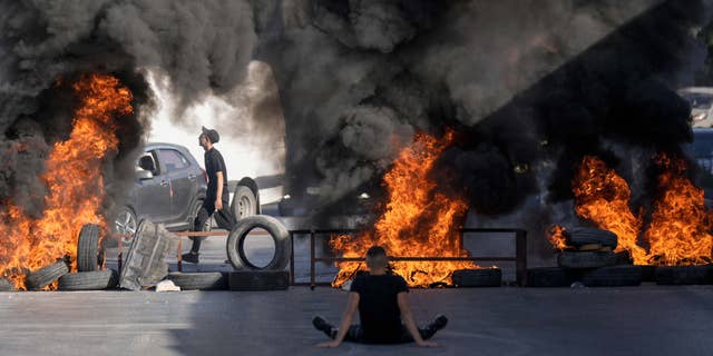 Tires were set on fire at the site where two Palestinians were shot and killed by Israeli forces in the Jalazone refugee camp near the city of Ramallah, West Bank, on Oct. 3, 2022.
