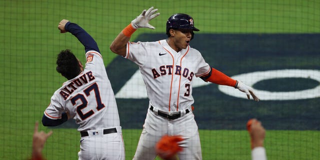 Jeremy Pena #3 of the Houston Astros celebrates a home run with Jose Altuve #27 during the seventh inning against the New York Yankees in game one of the American League Championship Series at Minute Maid Park on October 19, 2022 in Houston, Texas.