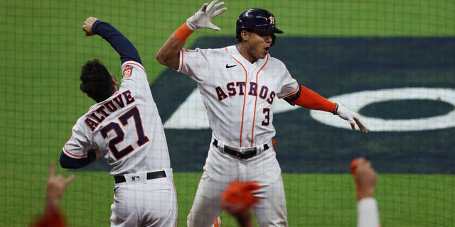 Jeremy Pena #3 of the Houston Astros celebrates a home run with Jose Altuve #27 during the seventh inning against the New York Yankees in game one of the American League Championship Series at Minute Maid Park on October 19, 2022 in Houston, Texas.