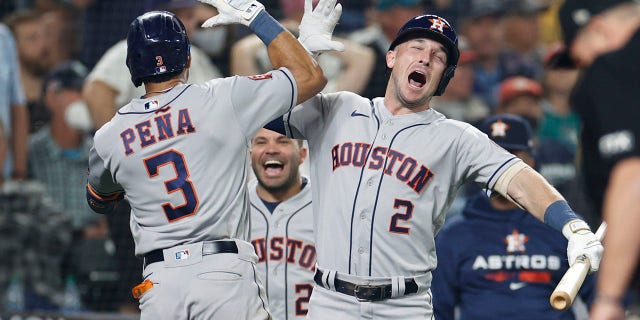 Jeremy Pena #3 of the Houston Astros reacts with Alex Bregman #2 after hitting a solo home run during the eighteenth inning against the Seattle Mariners in game three of the American League Division Series at T-Mobile Park on October 15, 2022 in Seattle, Washington.
