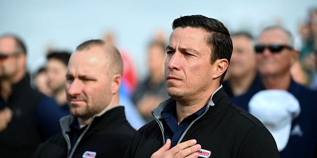 Former Army Captain Chris Cordova, center right, and other veterans stand at attention as the National Anthem is sung during the PGA Hope event at Congressional Country Club October 17, 2022 in Bethesda, MD. PGA Hope has specialized golf programs for veterans dealing with PTSD, brain injuries or other issues.