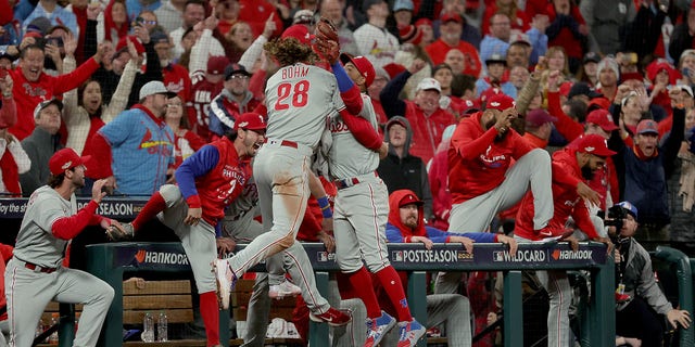 Edmundo Sosa #33 of the Philadelphia Phillies celebrates with Alec Bohm #28 after catching a foul ball to end the ninth inning and defeat the St. Louis Cardinals in game two to win the National League Wild Card Series at Busch Stadium on October 08, 2022 in St Louis, Missouri. The Philadelphia Phillies defeated the St. Louis Cardinals with a score of 2 to 0.