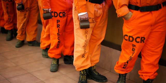 Prisoners in firefighter boots line up for breakfast at Oak Glen Conservation Fire Camp #35 in Yucaipa, California 