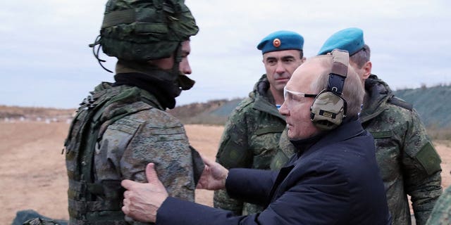 Russian President Vladimir Putin meet soldiers during a visit at a military training centre of the Western Military District for mobilised reservists, outside the town of Ryazan on Oct. 20, 2022. 