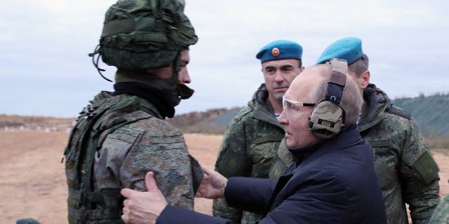 Russian President Vladimir Putin meet soldiers during a visit at a military training centre of the Western Military District for mobilised reservists, outside the town of Ryazan on Oct. 20, 2022. 