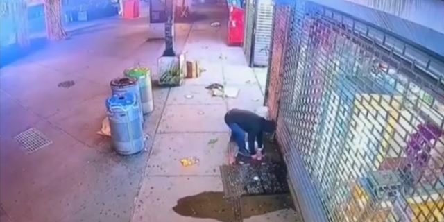 Security camera footage shows a man looking suspiciously at his surroundings before pouring a flammable liquid over the Ittadi Garden and Grill's storefront.