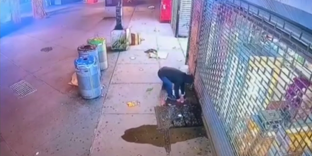 Security camera footage shows a man suspiciously eyeing his surroundings before dousing a flammable liquid over Ittadi Garden and Grill's storefront.