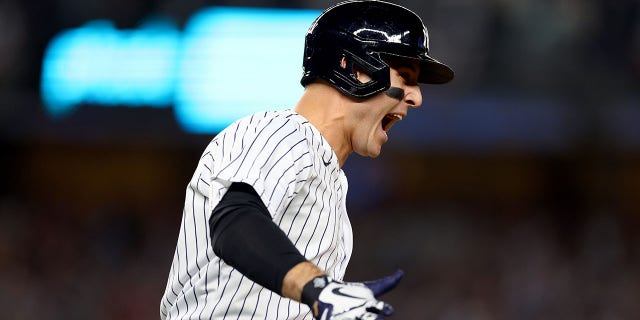 Anthony Rizzo #48 of the New York Yankees celebrates after hitting a two run home run against Cal Quantrill #47 of the Cleveland Guardians during the sixth inning in game one of the American League Division Series at Yankee Stadium on October 11, 2022 in New York, New York.