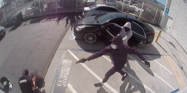 Security video captures two armed robbers shooting a Loomis guard during an armored car heist this week. The pair were arrested Friday and face federal charges.