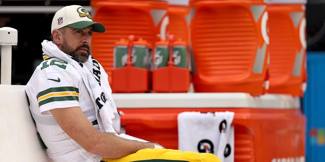 Aaron Rodgers of the Green Bay Packers looks on from the bench during the third quarter against the Washington Commanders at FedExField on Oct. 23, 2022, in Landover, Maryland.