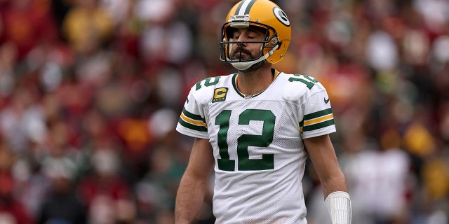 Aaron Rodgers #12 of the Green Bay Packers reacts after a play during the first quarter of the game against the Washington Commanders at FedExField on October 23, 2022 in Landover, Maryland.