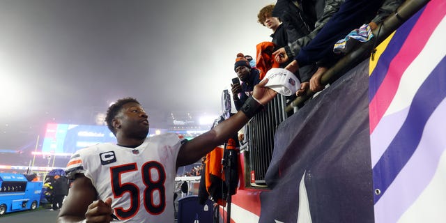 Roquan Smith #58 of the Chicago Bears signs autographs for fans after defeating the New England Patriots 33-14 at Gillette Stadium on Oct. 24, 2022 in Foxborough, Massachusetts.