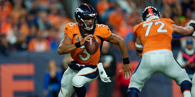 Russell Wilson (3) of the Denver Broncos fights against the Indianapolis Colts at Empower Field at Mile High on October 6, 2022 in Denver, Colorado.