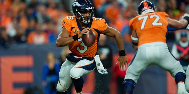 Russell Wilson (3) of the Denver Broncos fights against the Indianapolis Colts at Empower Field at Mile High on October 6, 2022 in Denver, Colorado.