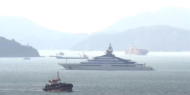 In this image taken from a video footage run by TVB, the megayacht Nord, center, worth over $500 million, is seen off Hong Kong Island outside Victoria Harbour on Friday, Oct. 7, 2022.