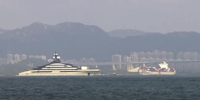 In this image taken from video footage run by TVB, the megayacht Nord, left, worth over $500 million, is seen off Hong Kong Island outside Victoria Harbour on Friday, Oct. 7, 2022.