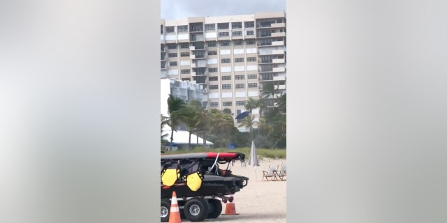 Blue beach umbrellas can be seen flying through the air during a storm in Florida.