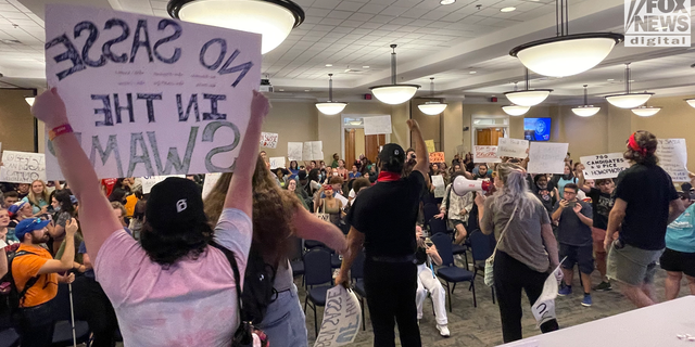 Students swarmed the room where Sasse was speaking after he left the area, jumping on the stage and continuing their chants.