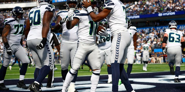 Marquise Goodwin #11 of the Seattle Seahawks celebrates after completing a touchdown reception in the first half of a game against the Los Angeles Chargers at SoFi Stadium in Inglewood, Calif., Oct. 23, 2022. 