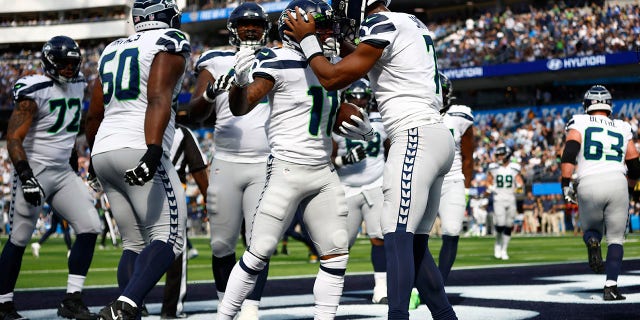 Marquise Goodwin #11 of the Seattle Seahawks celebrates after completing a touchdown reception in the first half of a game against the Los Angeles Chargers at SoFi Stadium in Inglewood, Calif., Oct. 23, 2022. 