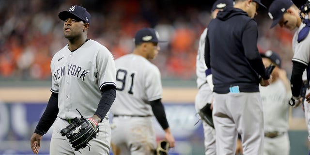 Luis Severino of the New York Yankees, left, walks off the mound after being removed during the sixth inning in Game 2 of the American League Championship Series against the Houston Astros at Minute Maid Park Oct. 20, 2022, in Houston.