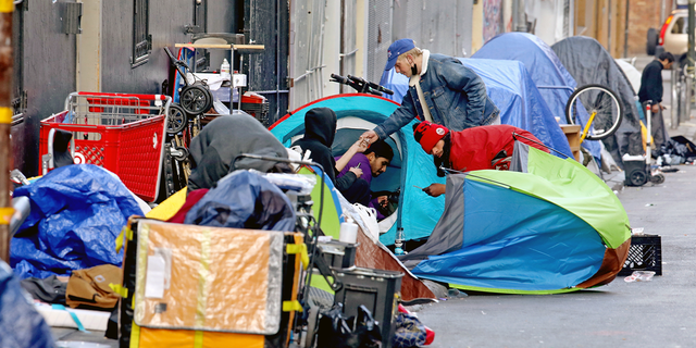 Homeless people consume illegal drugs in an encampment along Willow St. in the Tenderloin district of downtown on Thursday, Feb. 24, 2022 in San Francisco. London Breed, mayor of San Francisco, is the 45th mayor of the City and County of San Francisco. She was supervisor for District 5 and was president of the Board of Supervisors from 2015 to 2018.