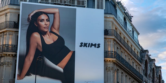 Kim Kardashian is seen posing in a SKIMS ad. Her company has come under fire for its sexual ads. 