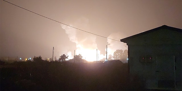 Flames and smoke rise from a military airbase Wednesday, Oct. 5, 2022, in Gangnueng, South Korea. South Korea’s Joint Chiefs of Staff said no injuries were reported from the explosion which involved a short-range Hyumoo-2 missile. (Kim Hee Soo via AP)