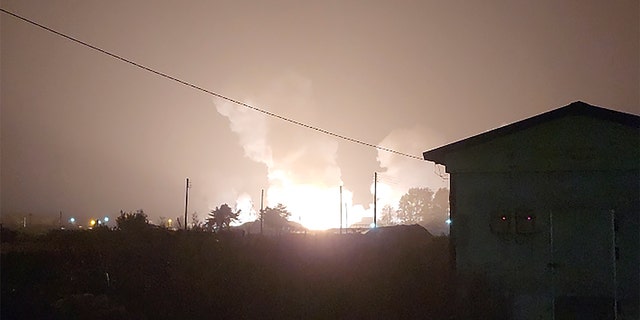 Flames and smoke rise from a military airbase Wednesday, Oct. 5, 2022, in Gangnueng, South Korea. South Koreas Joint Chiefs of Staff said no injuries were reported from the explosion which involved a short-range Hyumoo-2 missile. (Kim Hee Soo via AP)