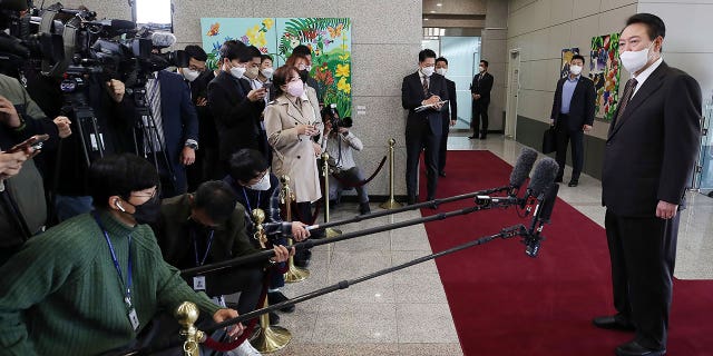 South Korean President Yoon Suk Yeol, right, speaks to reporters upon his arrival at the presidential office in Seoul, South Korea, Tuesday, Oct. 11, 2022. South Korea said Tuesday it’s capable of detecting and intercepting the variety of missiles launched in a barrage of recent simulated nuclear attacks on its rivals, though it maintains the North’s advancing nuclear program poses a grave security threat.