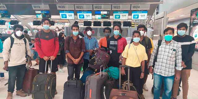 Indian workers rescued after they were lured by agents for fake job opportunities in the information technology sector in Thailand arrive at the airport in Chennai, India on Oct. 5, 2022,